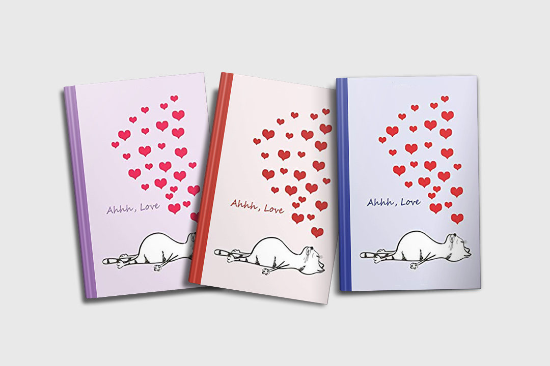 A set of three charming cat journals featuring a napping or sleeping tabby cat who is dreaming of love . Text says "Ahhh, Love" and there are hearts floating above the cat's sleeping form. There are three colors shown: purple, red, and blue.