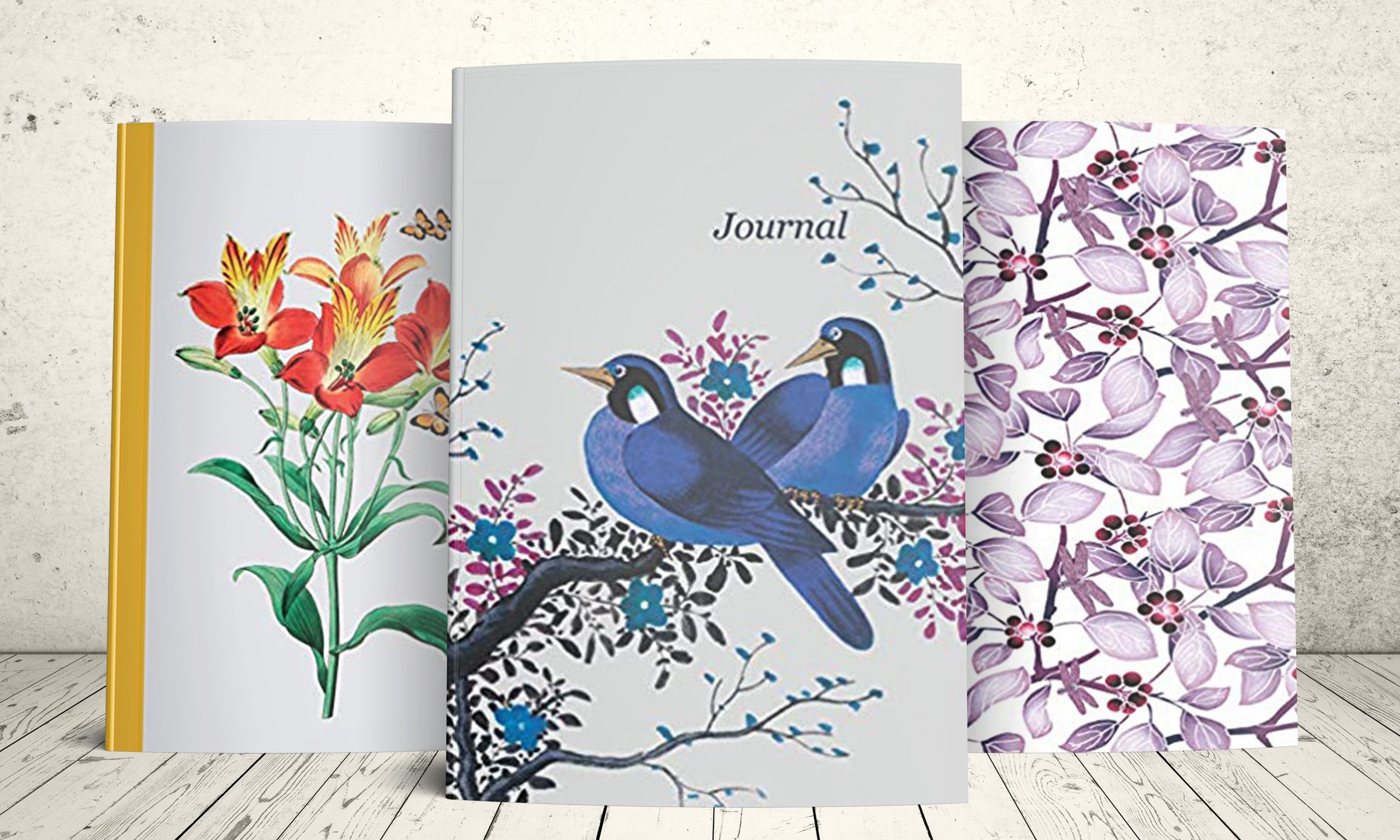 Three beautiful journals from Premise Content: Blue Birds, Yellow Watercolor Flowers, Purple Flowers and Dragonflies.