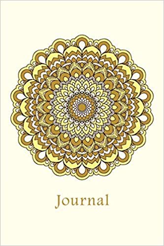 Notebook with yellow mandala and the word journal on the cover
