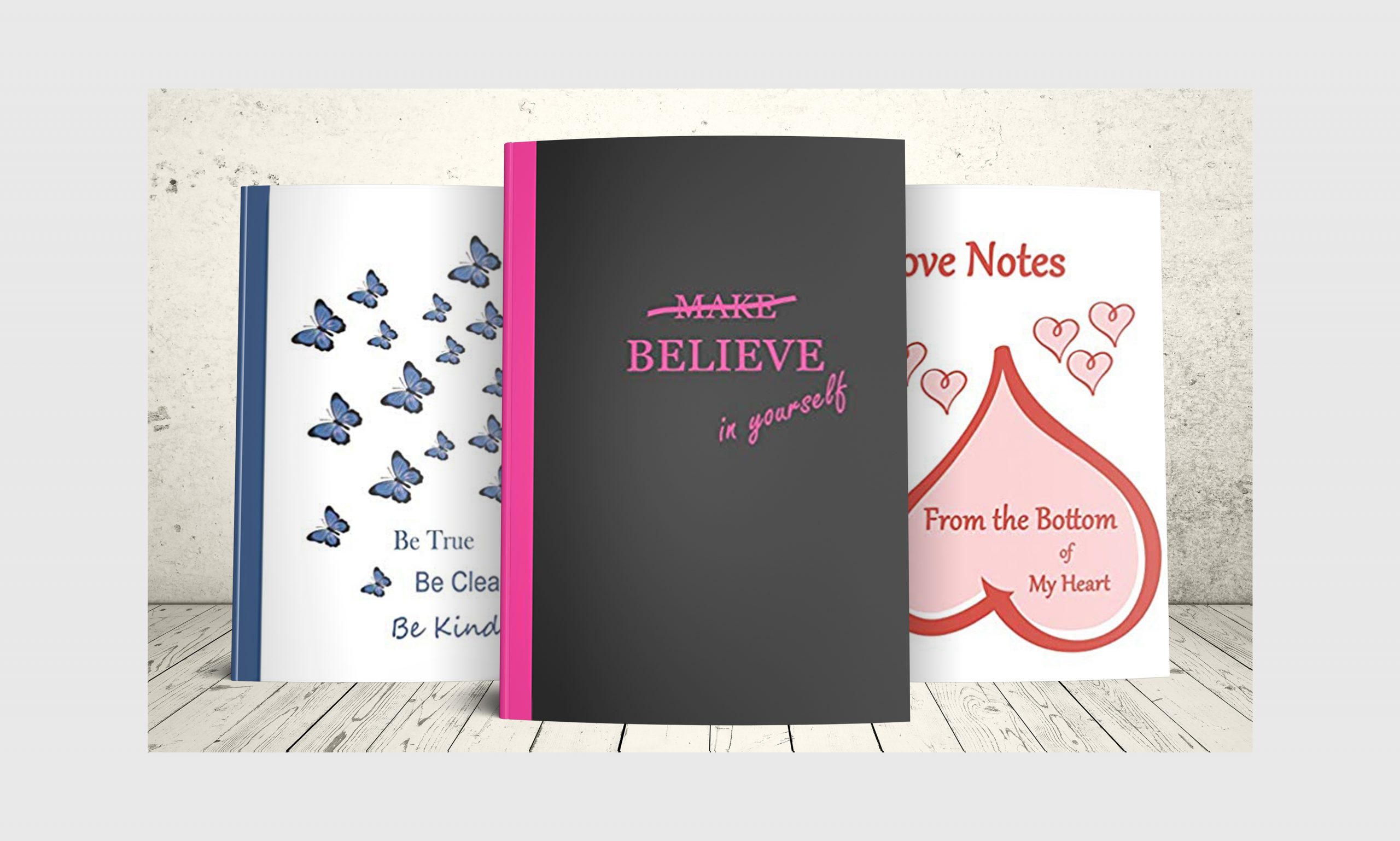 Three journals with motivational sayings on the cover.