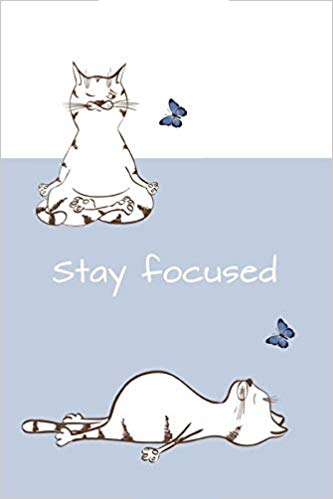 Blue and white journal notebook with two cartoon cats in yoga poses and blue butterflies on the cover. White text says stay focused.