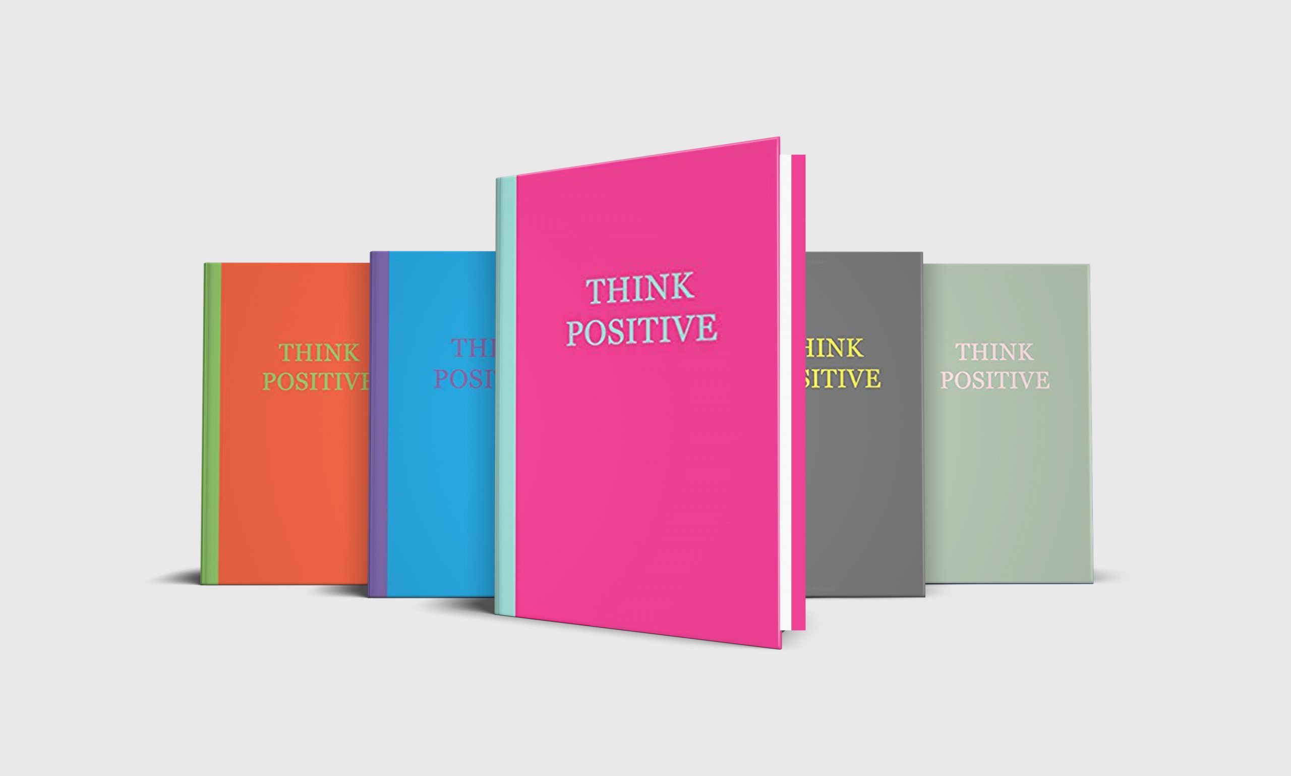 Five Think Positive journal notebooks in a variety of colors: pink, grey, sage green, blue and orange.