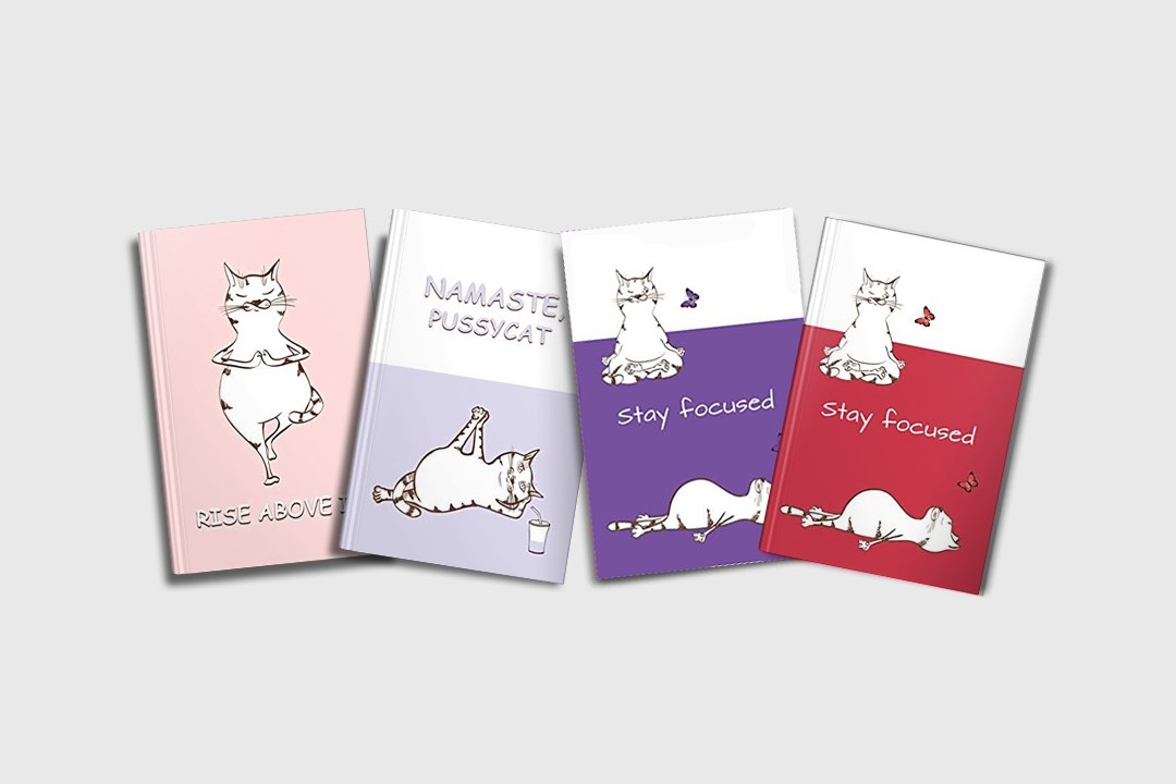 4 different journal covers with cats doing yoga on the cover in pink, light blue, purple and red.